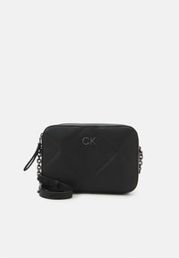 Borsa a tracolla nera trapuntata con hardware argentato, caratterizzata da un logo sul davanti e una tracolla removibile con accento in catena.