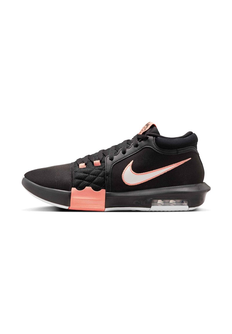 Black athletic shoe with a textured fabric upper, pink accents, white Nike swoosh, and a visible air cushion in the heel.