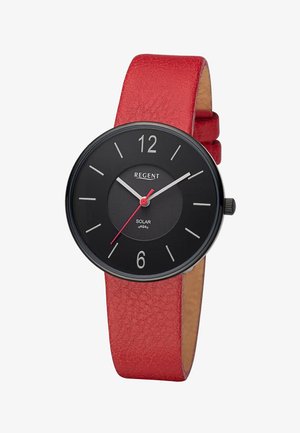 Cadran de montre rond noir avec des index blancs, une trotteuse rouge et un bracelet en cuir rouge texturé.