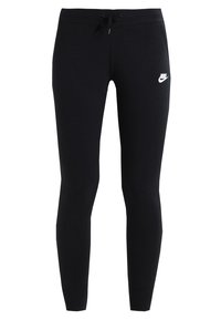 Svarta träningsbyxor i mjukt material, med en figurnära design, elastisk midja med snörning och en vit Nike-logotyp på låret.