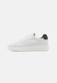 Weiße Ledersneaker mit glatter Oberfläche, abgerundeter Zehenpartie und schwarzem Lederakzent an der Ferse. Verfügt über eine Gummisohle und ein Schnürdesign.