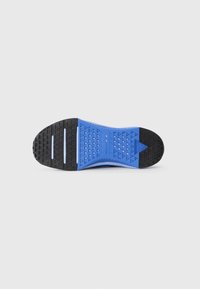 Blue and black shoe sole with a textured surface featuring triangular patterns and four grooves for traction.