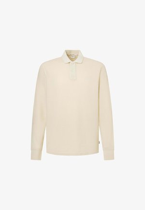 Pikendustega polo särk heleses kreemis, valmistatud pehmest kangast. Omab klassikalist kraed, kaht nööpi ja minimalistlikku logo.