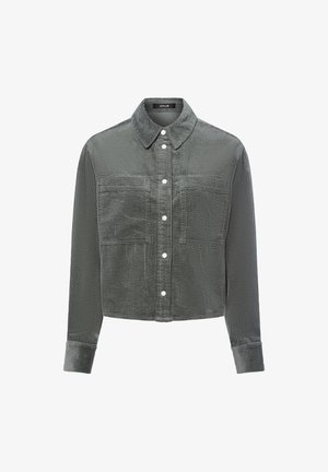 Grijze corduroy jas met een kraag, lange mouwen, knoopsluiting en twee voorzakken; heeft een ribbelstructuur en contrasterende knoophardware.