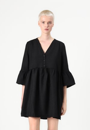Black dress with a V-neck, three-button closure, and flared sleeves. Features a tiered design and textured fabric.