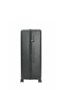 Black hard-shell suitcase with a textured surface, vertical zipper, side handle, and four wheels. Features a combination lock.