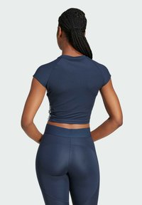 Navy ribbet kortærmet top med en tætsiddende design, parret med højtaljede leggings med teksturerede paneler i matchende farve.