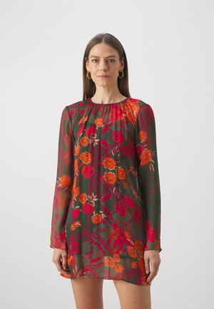 Halki vihreä mekko pitkillä hihoilla, jossa on punaisia ja oransseja kukkakuoseja sekä geometrisia yksityiskohtia. Pyöreä kaula-aukko, rento malli, polviin ulottuva.