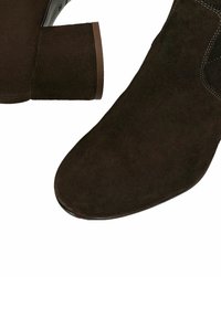 Dunkelbraune Wildleder-Stiefeletten mit Blockabsätzen und sichtbaren weißen Nähten an der Oberseite.