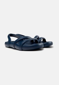 Navy blue rubber sandals featuring multiple curved straps, a soft texture, and a lightweight design with open sides for breathability.
