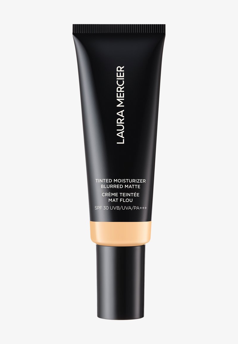 Svart tube med matt finish og en gylden bunn. Har hvit tekst: "Laura Mercier Tinted Moisturizer Blurred Matte," SPF 30.