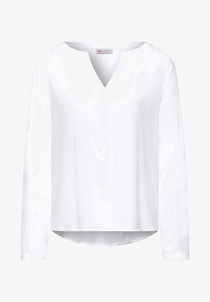 Blouse blanche à manches longues en tissu léger avec un décolleté en V et une patte de boutonnage. Présente un ourlet arrondi et des fronces subtiles aux épaules.