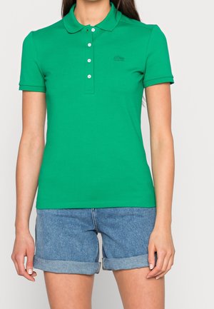 Groen poloshirt van katoen, met een klassieke kraag, knoopsluiting en een klein geborduurd logo op de borst. Gecombineerd met denim shorts.