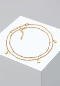 Collana a strati in oro con due catene che presentano accenti a disco rotondo e dettagli di perline. Le catene variano in spessore e texture. Chiusura regolabile.