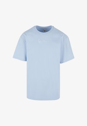 Helehall sinine puuvillane t-särk ümar kaelusega ja lühikeste varrukatega. Rinnal on peen valge logo tikand. Sile tekstuur.