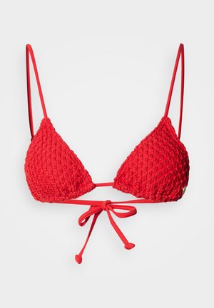 Red crochet bikini top with triangular cups, thin adjustable straps, and a tie closure at the center. Textured surface with detailing.
