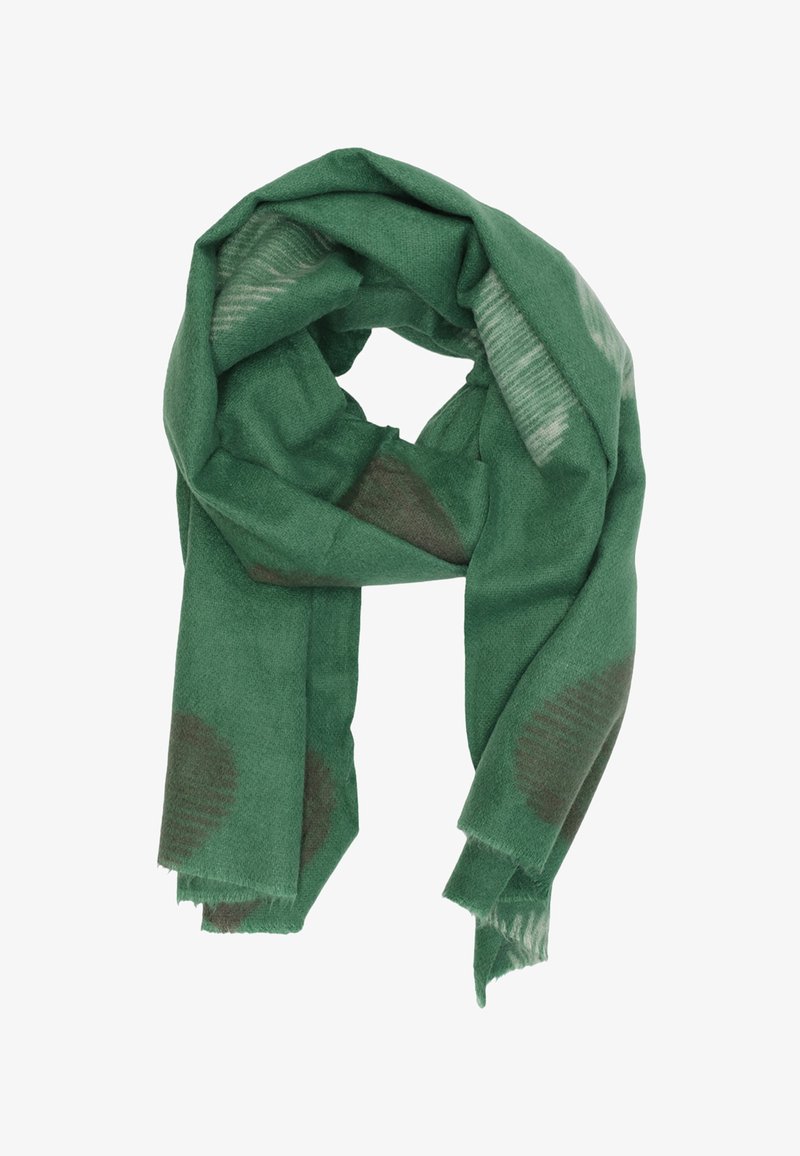 Scialle di lana verde con motivi circolari sottili, texture morbida e bordi leggermente sfilacciati, ripiegato in modo sciolto.