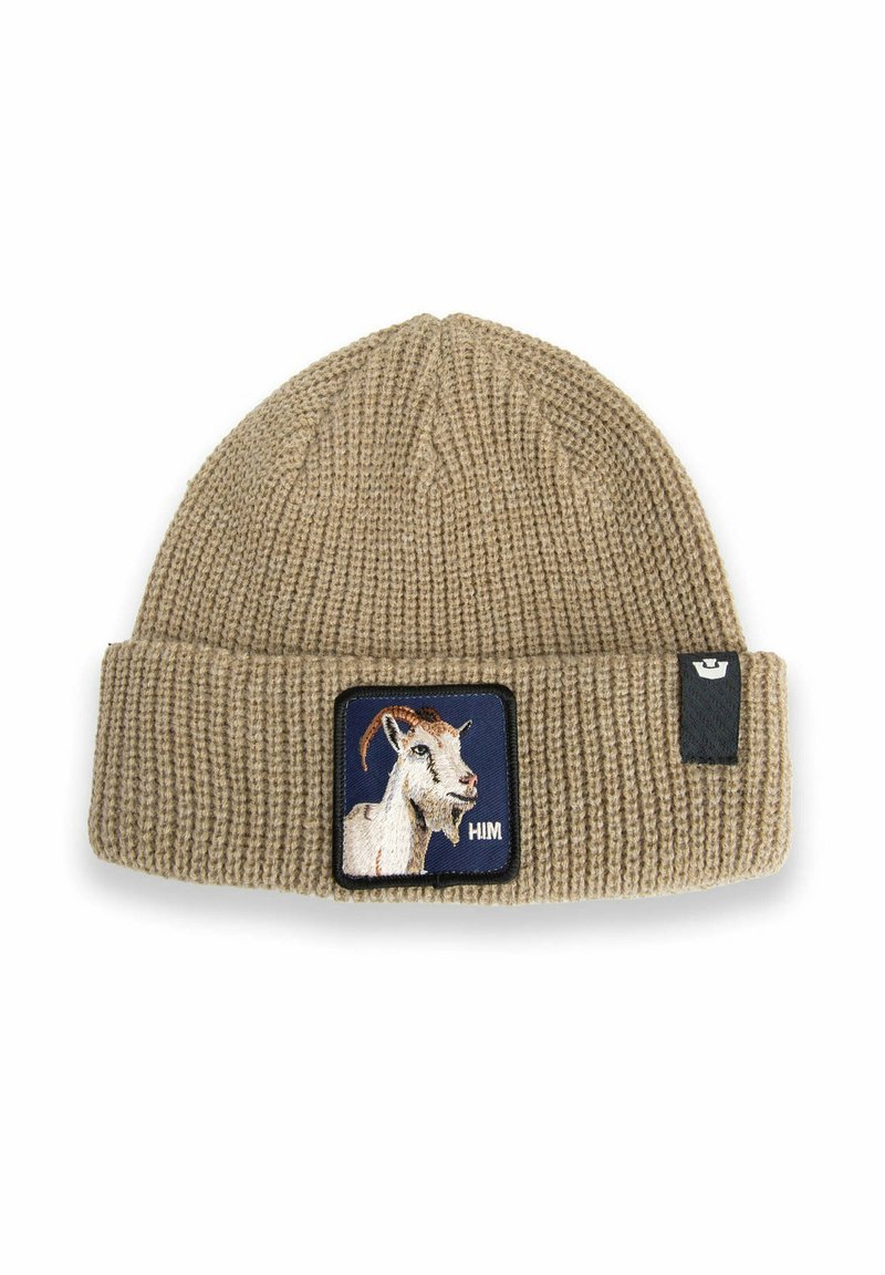 Beige knitted beanie with folded cuff, featuring a patch of a white goat head on navy background and a small black tag on the side.