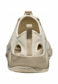 Scarpa beige slip-on con tomaia in rete, linguetta posteriore e dettagli laterali a taglio. Sole imbottito con motivo testurizzato per una presa sicura.