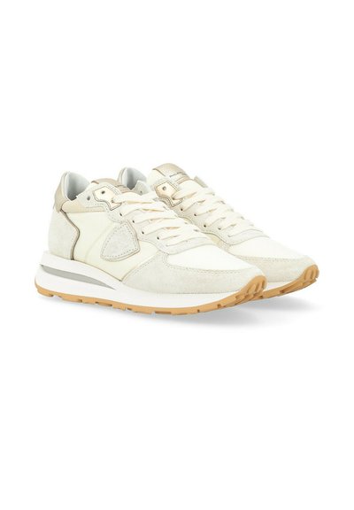 White suede sneakers featuring beige accents, a textured upper, and a gum rubber sole with a sporty design.