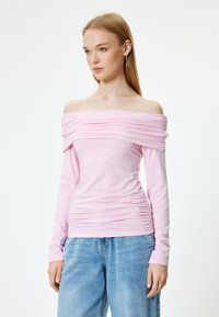 Rosa schulterfreies Oberteil aus weichem Stoff. Mit gerafftem Design entlang des Ausschnitts und der Seite, langen Ärmeln und taillierter Silhouette.