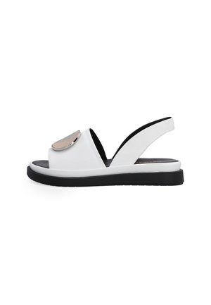 White leather slingback sandal with a black sole. Features a metallic accent on the front and an open-toe design.