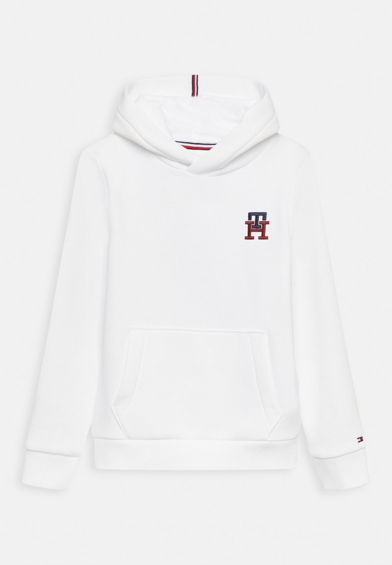 Sweat à capuche blanc avec poche avant, poignets et ourlet côtelés, petit logo "TH" rouge et marine sur la poitrine, et détail rayé à l'intérieur de la capuche.