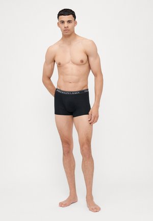 Schwarze Boxershorts mit einem weichen Bund, der das Logo "POLO RALPH LAUREN" trägt. Glattes Material, figurbetonte Form und mittelhoher Schnitt.