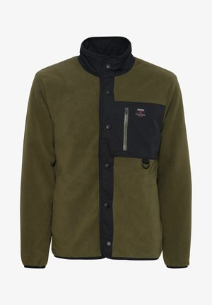 Veste en polaire vert olive avec des accents noirs, col montant, poche poitrine zippée et fermeture à boutons-pression. Tissu texturé, design décontracté.