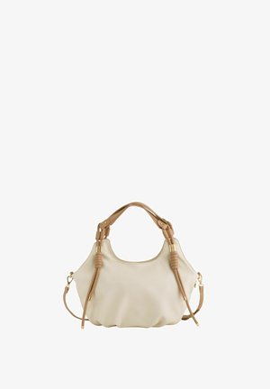 Beige weiche Lederhandtasche mit zwei braunen Griffen, dekorativen Knoten, goldfarbenen Beschlägen und einem abnehmbaren Schulterriemen.