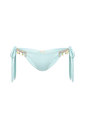 Vaaleansiniset bikinit alushousut, joissa on solmittavat sivukiinnitykset, ja vyötäisellä koristeena on kultaketju ja värikkäitä tarpeita. Silkkinen kangas