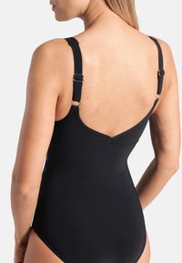 Black one-piece swimsuit featuring adjustable straps, a sleek fitted design, and a smooth texture, ideal for swimming or beachwear.