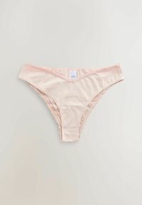 Thong pentru femei de culoare roz în formă de V, realizat dintr-un material moale, având accente din dantelă pe părțile laterale și o etichetă albă a brandului pe spate.