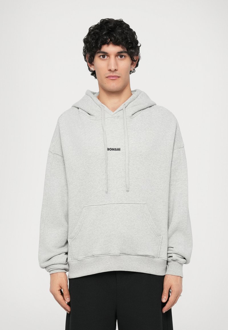 Light gray hoodie with a front pocket, drawstring hood, and the word "Bonsai" printed in black on the chest. Soft fabric and relaxed fit.