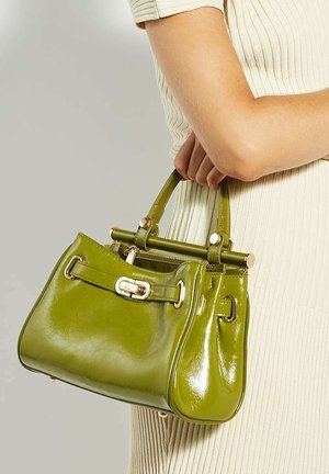 Green patent leather handbag with a structured shape, gold hardware accents, and a prominent top handle. Features a zippered closure and decorative strap.