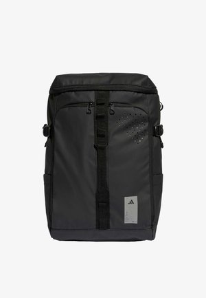 Black backpack made of durable fabric, featuring a front zip pocket, adjustable straps, textured accents, and a logo tag on the lower front.