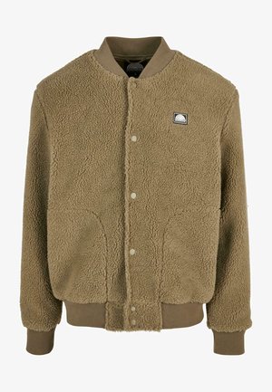 Ruda fleece striukė su struktūrizuotu bombonešio dizainu, gumuotomis rankovėmis ir apačioje, užtrauktukais ir mažu logotipo užrašu ant krūtinės.