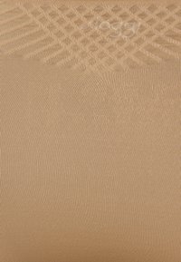 Beige, ribbed fabric with a smooth texture and subtle sheen, featuring a repeating hexagonal pattern throughout.