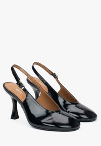 Zwarte gepatineerde leren slingback-hakken met puntige neuzen, een smalle enkelriem en een flared stiletto-hak. Glad, glanzend oppervlak.
