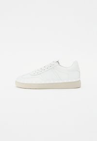Baskets en cuir blanc avec une texture lisse, bout rond, design à lacets, semelle en caoutchouc de couleur claire et accents latéraux subtils pour le détail.