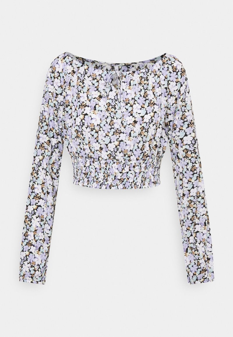 Blouse courte à manches longues avec taille élastique et motif floral violet clair, blanc et beige sur fond noir.