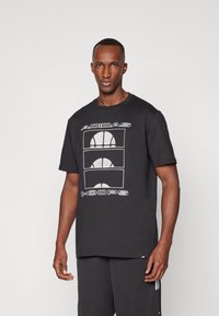 Crna pamučna majica s grafikom koja prikazuje tri dizajna košarkaške lopte i tekst "ADIDAS HOOPS" u bijeloj boji. Kratki rukavi i okrugli izrez.
