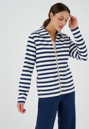 Marineblauw en witte gestreepte zip-up jas met kraag, twee voorzakken en gouden ritsdetails. Katoenmengsel materiaal, relaxte pasvorm.