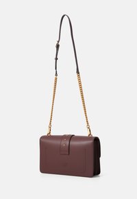 Burgundy leather handbag with a chain strap, featuring a flap closure, gold hardware, and studded accents. Smooth texture, rectangular shape.