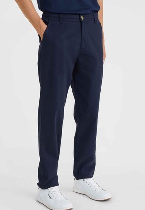 Navy straight-leg pants made of soft cotton fabric, featuring side pockets, a button closure, and paired with white sneakers.