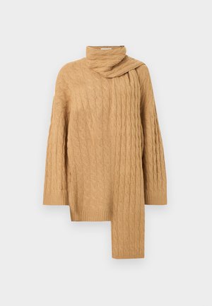 Cable-knit sweater in light brown. Features a high collar and an asymmetrical hem with a draped scarf detail on one side. Soft texture.