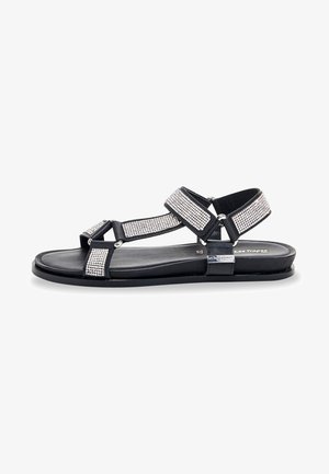 Sort sandal med rhinsten accenter, der har justerbare stropper, flad sål og minimalistisk design. Glat tekstur og holdbare materialer.