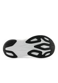 Suola di scarpa sportiva in bianco e nero con superficie in gomma testurizzata caratterizzata da più motivi e scanalature per una maggiore trazione e flessibilità.
