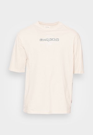 T-shirt en coton beige à manches courtes, avec un design graphique noir à l'avant, encolure ronde et coupe décontractée.