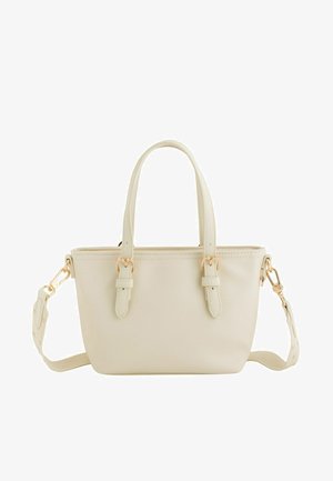 Cream-colored handbag with two short handles, detachable long strap, and gold-tone buckle details on a white background.